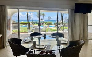 a dining room table with chairs and a view of the ocean at Las Villas Akumal in Akumal
