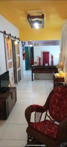 a living room with a chair and a table at Casa Mia in Caruaru