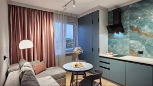 a living room with a couch and a table at Blue Apartment in Mukacheve