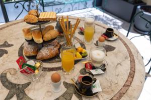 a table with breakfast foods and drinks on it at Domus Deorum Deluxe in Naples +72 photos