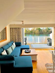 a living room with a blue couch and a table at Herons Hideout in South Cerney