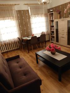 a living room with a couch and a table at Dzīvoklis Vecliepājā in Liepāja