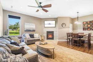 a living room with a couch and a table at Bee Creek Poolside in Branson