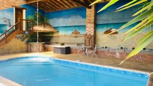 a large swimming pool with a table and a table at Chambres d'Hôtes Au Clos Saint Georges in Saint-Jory