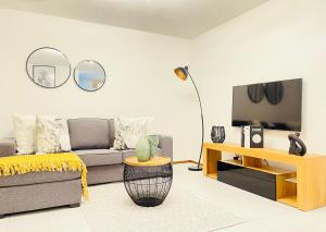 a living room with a couch and a tv at Sea Sunny View Apartment in Margate