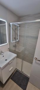 a bathroom with a shower and a sink at Salinetas apartamento junto al mar in Telde +6 photos