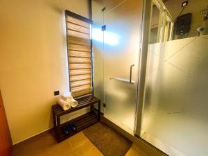 a shower stall in a bathroom with a window at Cruzian Bliss in Negombo