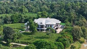 an aerial view of a house on a hill at Vaani Greens Wildlife Resort, Kaziranga in Kuthari
