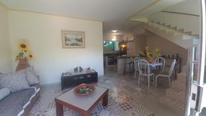 a living room with a couch and a table at Souzas House in Vera Cruz de Itaparica +11 photos