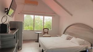Voodi või voodid majutusasutuse Apartahotel la Posada Suite toas