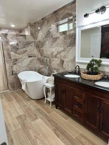 a bathroom with two sinks and a bath tub at Hitching Post in Vernal +21 photos