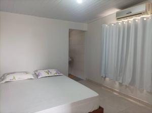 Ένα ή περισσότερα κρεβάτια σε δωμάτιο στο Casa aconchegante no centro