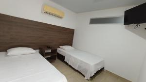 Voodi või voodid majutusasutuse Apartahotel la Posada Suite toas