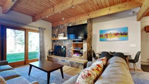 a living room with a couch and a tv at Timberline Condominiums 1 Bedroom Deluxe Unit B1C in Snowmass Village
