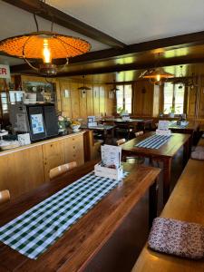 a restaurant with wooden tables and chairs and a counter at Berggasthaus Rigi-Burggeist in Gersau
