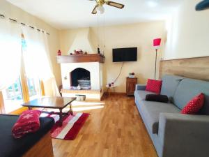 a living room with a couch and a fireplace at Appartamento Acero Rosso in Borno
