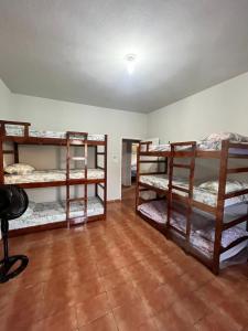 a room with three bunk beds and a camera at Kariri Hostel in Crato