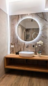 a bathroom with a sink and a mirror at CHERRY BLOSSOM Apartments in Legnano