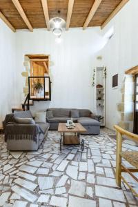 a living room with a couch and a table at Xanthippi's Traditional House in Pemonia in Pemónia