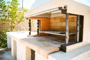 a brick oven sitting on top of a table at Xanthippi's Traditional House in Pemonia in Pemónia