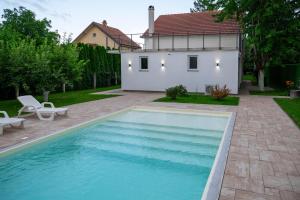 a swimming pool in the yard of a house at One24 House in Čortanovci