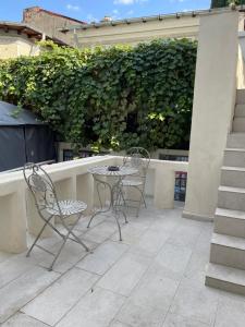 two chairs and a table on a patio at Milennium Apart Hotel in Bucharest