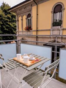 a table and chairs sitting on a balcony at CHERRY BLOSSOM Apartments in Legnano