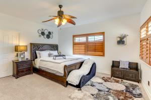 a bedroom with a bed and a chair and a chandelier at Hesperia Home Near Mojave River and Hiking Trails! in Hesperia