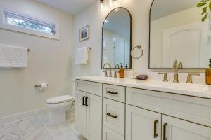 a bathroom with a toilet and a sink and a mirror at 6 Mi to Appalachian Trail Modern Front Royal Gem! in Paris +22 photos