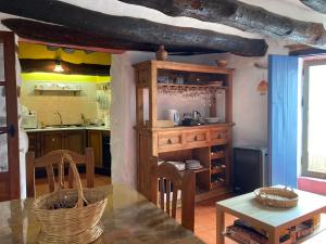 a kitchen with a counter and a table in a room at Casa Ajelazul in Galaroza
