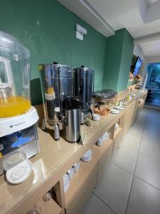 a kitchen with a counter with a bunch of appliances at Parque Hotel Cordeiro in Cordeiro