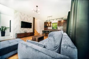 a living room with a couch and a table at Jurajski Zakątek in Skała