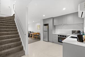 a kitchen with stairs leading to a dining room at Lovely 2BR Home close to Center in Christchurch