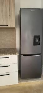 a stainless steel refrigerator in a kitchen at Maison indépendante in Hammamet Nord