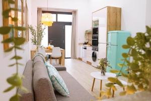 a living room with a couch and a kitchen at La Brisa Lofts in Valencia +40 photos