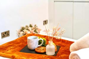 a table with a coffee mug and cookies on it at GioEstate Holiday, with Free Parking, Flat28 in Brighton & Hove