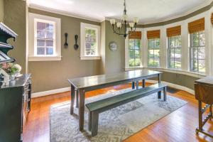 a dining room with a table and some windows at Fire Pit, Large Yard Midtown Columbus Bungalow! in Columbus