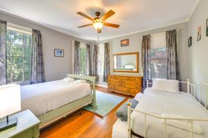 a bedroom with two beds and a ceiling fan at Fire Pit, Large Yard Midtown Columbus Bungalow! in Columbus