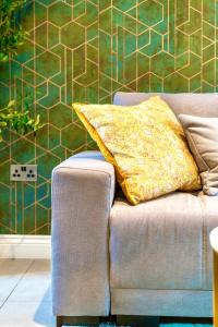 a yellow pillow sitting on a couch in a room at GioEstate Holiday, with Free Parking, Flat28 in Brighton & Hove