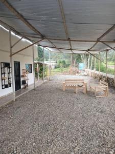 a pavilion with two benches in a building at Casa Azul in Sibundoy +9 photos