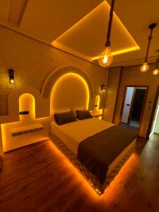 a bedroom with a large bed in a room with lights at Appartement Fes Sami Haut Standing in Fès