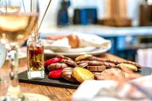 a table with a plate of food and a glass of wine at GioEstate Holiday, with Free Parking, Flat28 in Brighton & Hove