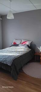 a bedroom with a bed with pillows on it at Peaceful Oasis by East Center in Helsinki