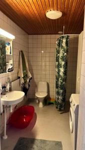 a bathroom with a toilet and a sink and a shower at Peaceful Oasis by East Center in Helsinki