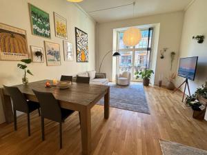 a living room with a table and chairs and a living room at Botanical Bliss in OSLO! in Oslo