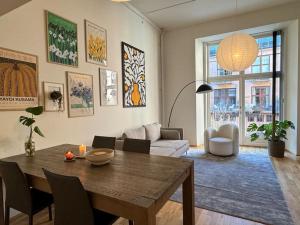 a living room with a table and a couch at Botanical Bliss in OSLO! in Oslo