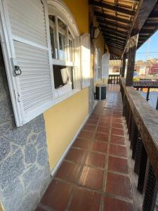a porch of a house with a tiled floor at Casa da Lua Centro in Búzios