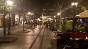 a street at night with people walking down the street at Modern Apartment in Belgrade Most Central Location in Belgrade