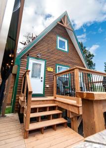 a house with a large deck with a staircase at Hillside Haven 1 Bedroom with Hot Tub in Sussex