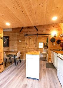 a kitchen and dining area of a log cabin at Hillside Haven 1 Bedroom with Hot Tub in Sussex